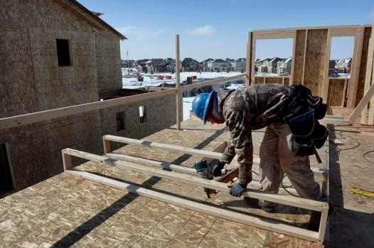 Construction Worker Building secondary level of a New Home