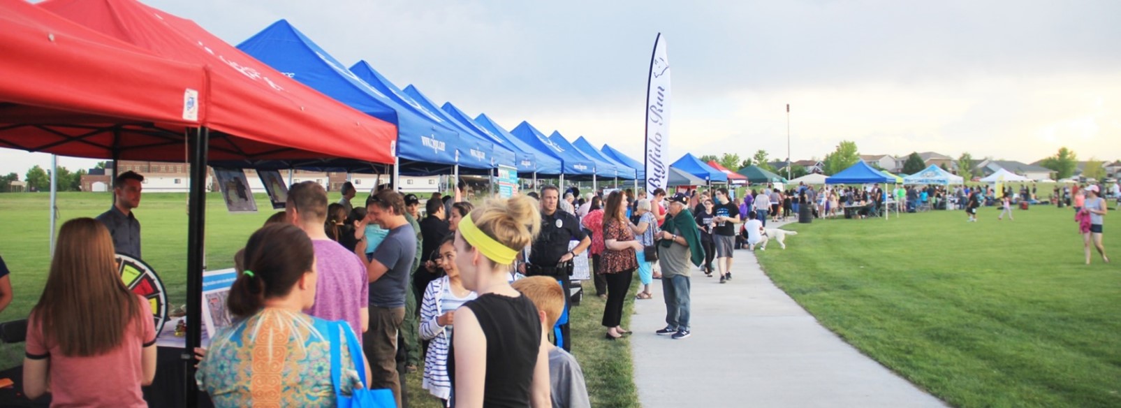 Public event along a green space sidewalk