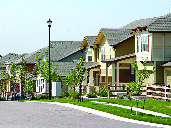 Image of a street in the Reunion Neighborhood. Single Family Homes are visible.