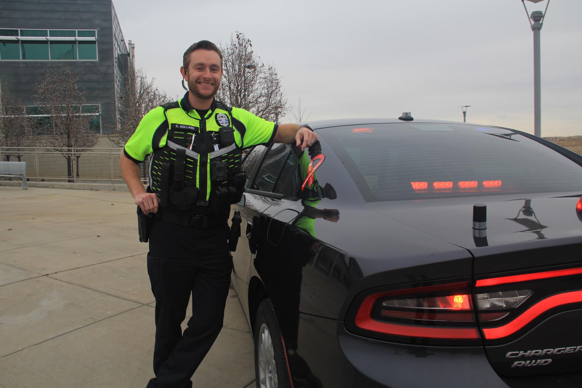 Curt Holland standing next to a PD Car