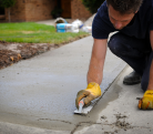 Image of a person working on a driveway